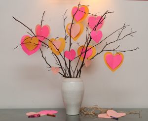 A Valentine tree made of twigs in a vase with pink paper hearts