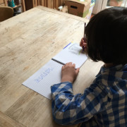 Ronan with Binky Bear Writing Book